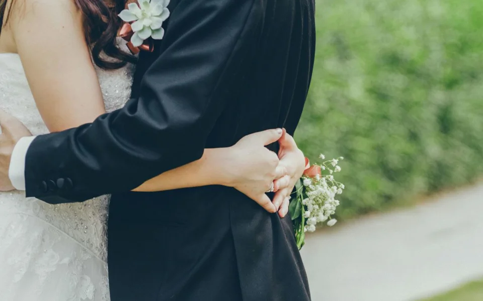 A Couple Hugging During Their Wedding Day