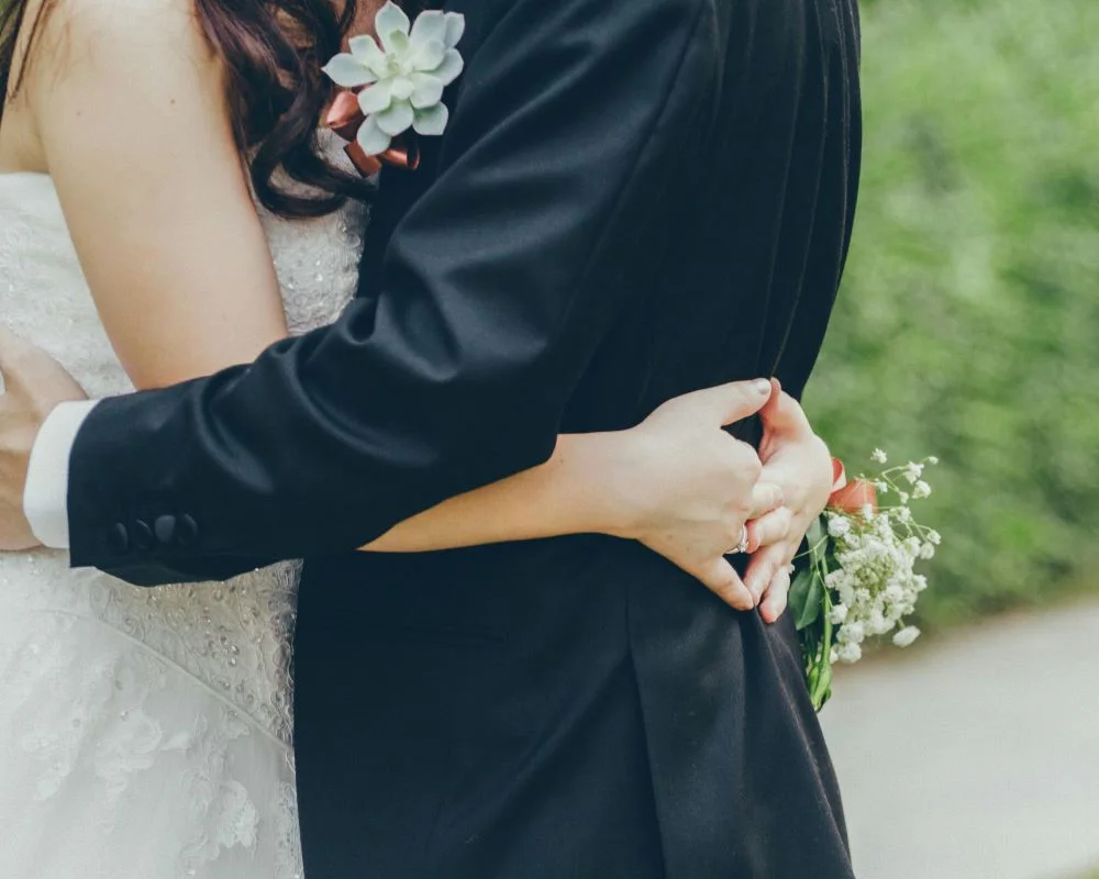 Couple Hugging During Their Wedding Day